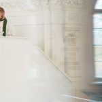 A preacher standing at a pulpit inside a historic church during a religious ceremony.